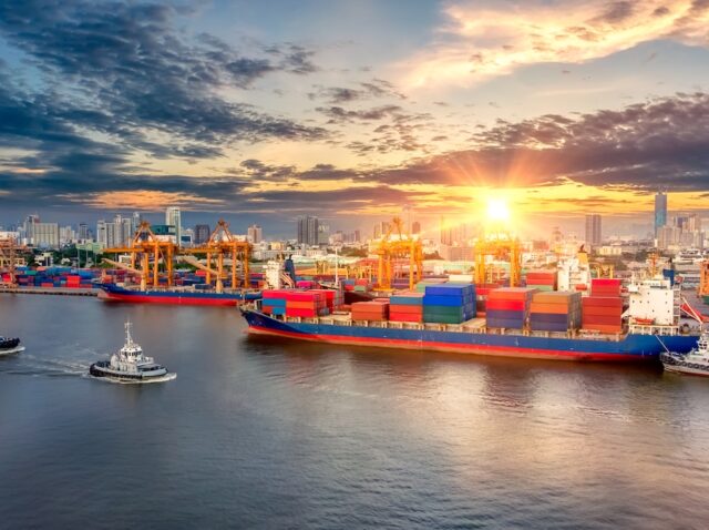 Aerial view of cargo ship, cargo container in warehouse harbor at thailand, container ship in import export and business logistic with sunset